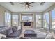 Comfortable living room with a large sectional couch, built-in shelving, and natural light at 5855 Boulder Brook Ct, Las Vegas, NV 89149