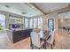 Open-concept living room with modern decor, backyard view, and dining area with seating for six at 5855 Boulder Brook Ct, Las Vegas, NV 89149