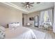 Large main bedroom with a tray ceiling, ceiling fan, and wood-look floors at 5855 Boulder Brook Ct, Las Vegas, NV 89149