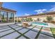 Stunning backyard featuring a refreshing pool, outdoor lounge area, and manicured landscaping at 5855 Boulder Brook Ct, Las Vegas, NV 89149