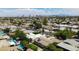 Expansive aerial view showcasing neighborhood with lush trees, swimming pools, and the Las Vegas skyline at 6320 Shawnee Ave, Las Vegas, NV 89107