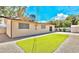 Backyard view with synthetic lawn and detached living quarters at 6320 Shawnee Ave, Las Vegas, NV 89107