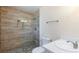 Bathroom with modern shower, stone flooring, toilet and sink with white vanity at 6320 Shawnee Ave, Las Vegas, NV 89107