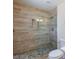 Stylish bathroom shower featuring decorative tiling and pebble flooring at 6320 Shawnee Ave, Las Vegas, NV 89107