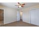 Carpeted bedroom includes a closet, ceiling fan, and an en-suite bathroom at 6320 Shawnee Ave, Las Vegas, NV 89107
