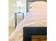 Bright bedroom featuring neutral decor with a modern lamp on the nightstand at 6320 Shawnee Ave, Las Vegas, NV 89107