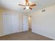 Bright bedroom features carpet, closet, ceiling fan, and white trim at 6320 Shawnee Ave, Las Vegas, NV 89107