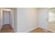 Hallway with light walls, modern door, and wood-look flooring at 6320 Shawnee Ave, Las Vegas, NV 89107