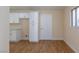 Updated kitchen features white cabinets and door to living space at 6320 Shawnee Ave, Las Vegas, NV 89107