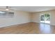 Spacious living area with ceiling fan, light walls, and sliding glass door access to the yard at 6320 Shawnee Ave, Las Vegas, NV 89107