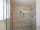 Beautiful bathroom with a shower featuring glass surround and decorative stone at 6320 Shawnee Ave, Las Vegas, NV 89107