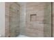 Beautiful shower featuring new horizontal tiling, glass door, and a built-in niche for toiletries at 6320 Shawnee Ave, Las Vegas, NV 89107