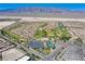 Aerial shot of Sun City Aliante featuring a golf course, community center, and desert mountains at 6480 Chebec St, North Las Vegas, NV 89084
