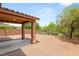 Expansive backyard with covered patio, low-maintenance landscaping, and block wall for privacy at 6480 Chebec St, North Las Vegas, NV 89084