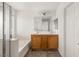 Bright bathroom with double sink vanity, shower, and bathtub at 6480 Chebec St, North Las Vegas, NV 89084