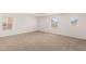 Spacious carpeted bedroom with neutral walls and multiple windows allowing natural light at 6480 Chebec St, North Las Vegas, NV 89084