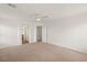 Carpeted bedroom with attached bathroom, neutral walls and a ceiling fan at 6480 Chebec St, North Las Vegas, NV 89084