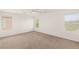 Spacious bedroom featuring a ceiling fan, neutral walls and plush carpet at 6480 Chebec St, North Las Vegas, NV 89084