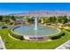 Scenic view of Sun City Aliante entrance with a water fountain and mountain backdrop at 6480 Chebec St, North Las Vegas, NV 89084