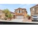 Charming two-story home featuring a two-car garage and desert landscaping in a sunny neighborhood at 6480 Chebec St, North Las Vegas, NV 89084