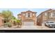 Charming two-story home featuring a two-car garage and desert landscaping in a sunny neighborhood at 6480 Chebec St, North Las Vegas, NV 89084