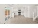 Bright kitchen with stainless steel appliances, white cabinets, and modern wood-look flooring at 6480 Chebec St, North Las Vegas, NV 89084