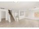 Bright living room featuring modern wood-look tile flooring and a staircase at 6480 Chebec St, North Las Vegas, NV 89084