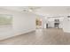 Open concept living space featuring stainless steel appliances, white cabinetry and wood-look flooring at 6480 Chebec St, North Las Vegas, NV 89084