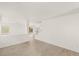 Bright living room featuring modern wood-look tile flooring and staircase at 6480 Chebec St, North Las Vegas, NV 89084