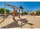 Outdoor playground with climbing structures, swings, and shaded seating areas, providing a fun recreational space for families at 6480 Chebec St, North Las Vegas, NV 89084