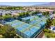 Aerial view of a community tennis and pickle ball court complex. Several blue and green courts with modern amenities at 6480 Chebec St, North Las Vegas, NV 89084