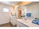 Bright bathroom featuring double vanity, modern fixtures, and a walk-in closet at 6529 Cinnamon Hazelnut Ave # Lot 93, North Las Vegas, NV 89084