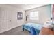 Bedroom featuring a skateboard, modern desk, blue accent wall and plush carpeting at 6529 Cinnamon Hazelnut Ave # Lot 93, North Las Vegas, NV 89084