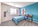 Stylish bedroom with a blue accent wall, a desk, and a modern design at 6529 Cinnamon Hazelnut Ave # Lot 93, North Las Vegas, NV 89084
