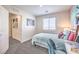Cozy bedroom with pink accent wall, desk, modern lighting and neutral carpeting at 6529 Cinnamon Hazelnut Ave # Lot 93, North Las Vegas, NV 89084