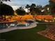 Relaxing backyard featuring a pool, palm trees, artificial grass, and patio furniture under a twilight sky at 6756 Sea Swallow St, North Las Vegas, NV 89084