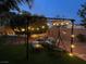 Cozy backyard featuring a pergola with string lights, comfortable seating, and well-manicured landscaping at 6756 Sea Swallow St, North Las Vegas, NV 89084
