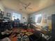 Inviting bedroom with a floral rug, ceiling fan, and lots of natural light at 6756 Sea Swallow St, North Las Vegas, NV 89084