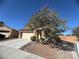 Charming two-story home features a two car garage and landscaped front yard under a clear blue sky at 6756 Sea Swallow St, North Las Vegas, NV 89084
