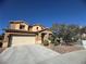 Charming two-story home features a two car garage and landscaped front yard under a clear blue sky at 6756 Sea Swallow St, North Las Vegas, NV 89084