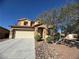 Charming two-story home features a two car garage and landscaped front yard under a clear blue sky at 6756 Sea Swallow St, North Las Vegas, NV 89084