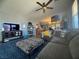 Cozy living room featuring hardwood floors, TV, and comfortable gray sectional sofa at 6756 Sea Swallow St, North Las Vegas, NV 89084