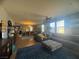 Spacious living room featuring hardwood floors, large windows, and a comfortable gray sectional sofa at 6756 Sea Swallow St, North Las Vegas, NV 89084
