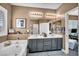 Bright bathroom with a double sink vanity, soaking tub and a view to the home office through the open door at 7029 Bocaire Dr, Las Vegas, NV 89131