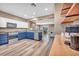 Spacious open kitchen with stainless steel appliances, blue cabinets, wood floors and modern lighting at 7029 Bocaire Dr, Las Vegas, NV 89131