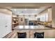 Bright kitchen featuring wood floors, stainless steel appliances, white cabinets, and a breakfast bar at 7029 Bocaire Dr, Las Vegas, NV 89131