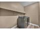 Modern laundry room features gray washer and dryer, neutral walls, and sleek, minimalist design at 7029 Bocaire Dr, Las Vegas, NV 89131