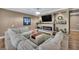 Comfortable living room with a fireplace, TV, and large sectional sofa at 7029 Bocaire Dr, Las Vegas, NV 89131