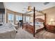 Main bedroom boasts four poster bed, sitting area, and shutters at 7029 Bocaire Dr, Las Vegas, NV 89131