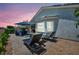 Stylish outdoor living space with lounge chairs, dining, and relaxing seating around the fire pit at 7029 Bocaire Dr, Las Vegas, NV 89131